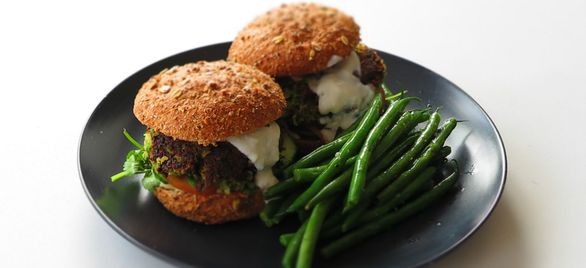 Falafel burger with herb aioli and sumac green beans