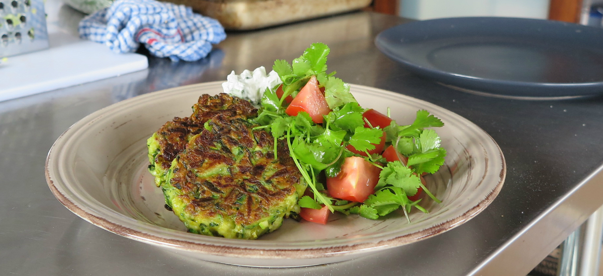 Curried courgette fritters with basmati, raita, sweet mango pickle, tomato and coriander salad