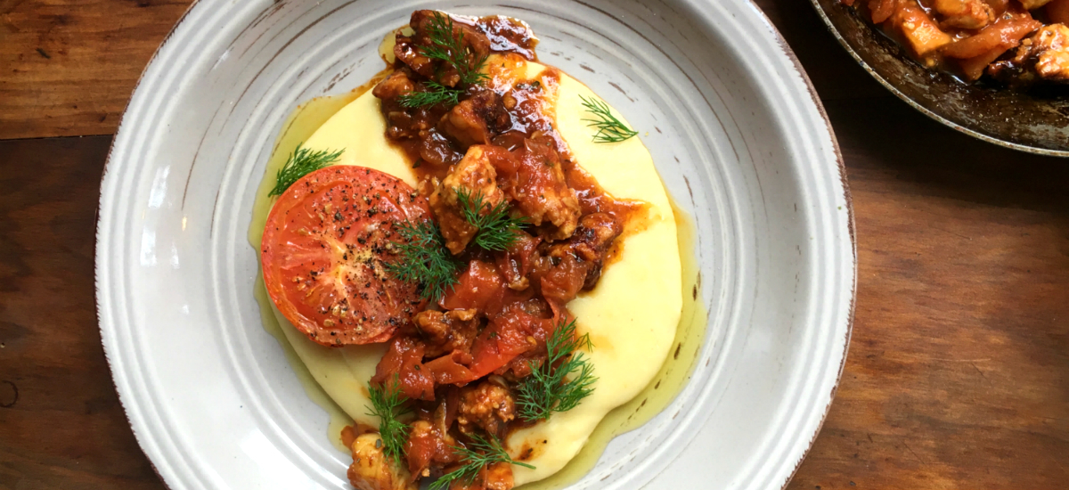 Creamy polenta with tempeh sausage, roast tomato, baby kale and parsley