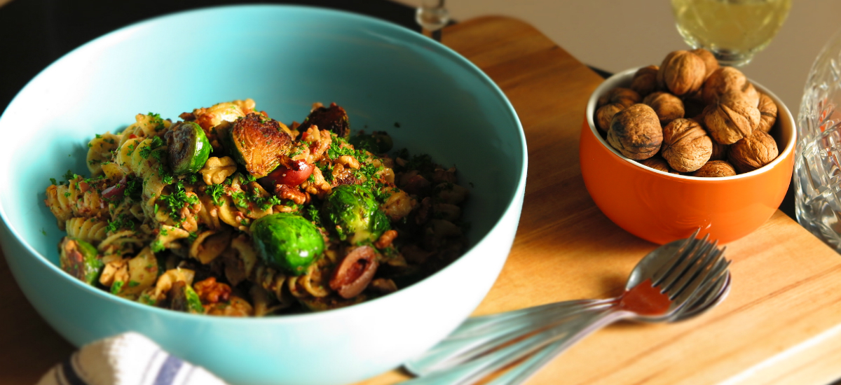 Walnut and olive tapenade pasta with seared Brussels sprouts and cherry tomatoes