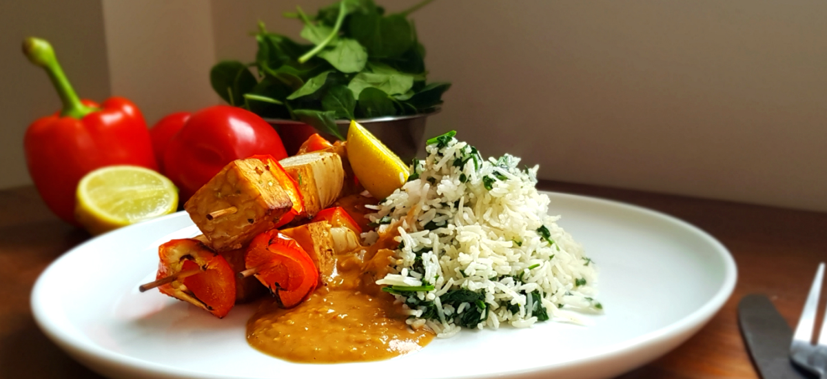 Tempeh kebabs with satay sauce and creamy leek and garlic rice