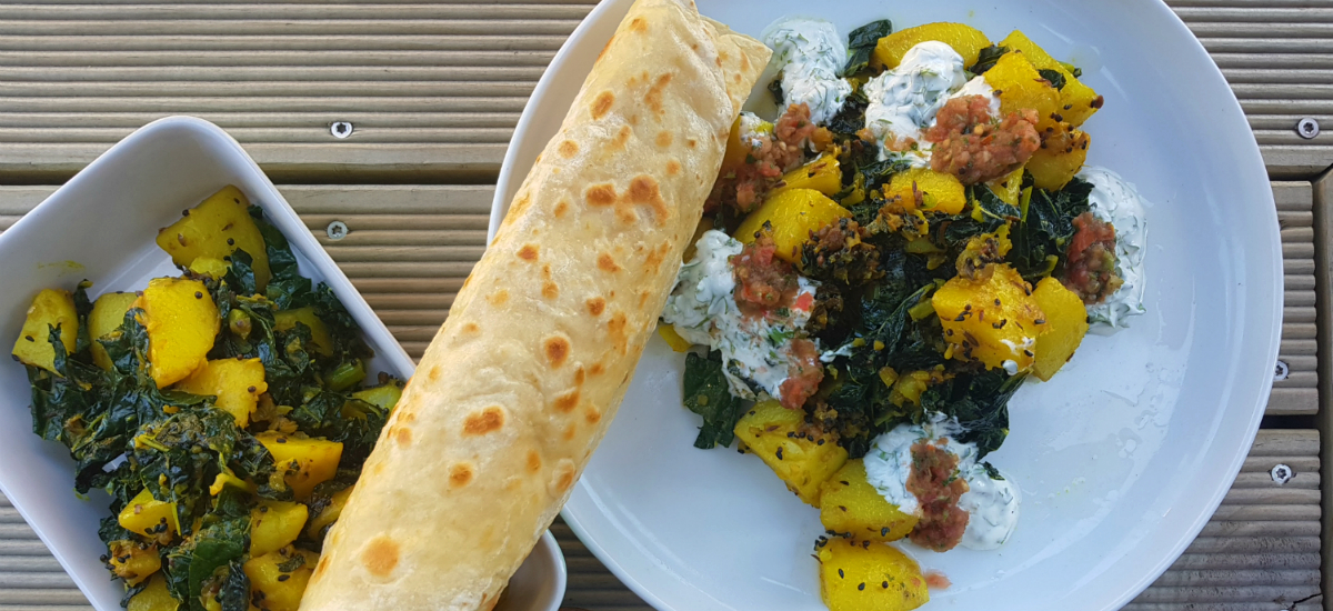 Bombay potatoes and cavolo nero with achar sauce, yoghurt and flat breads