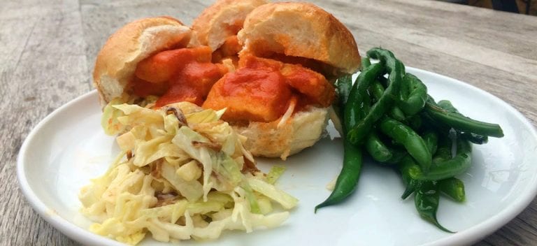 Buffalo tofu sliders served with caramelised onion slaw and lemony beans.