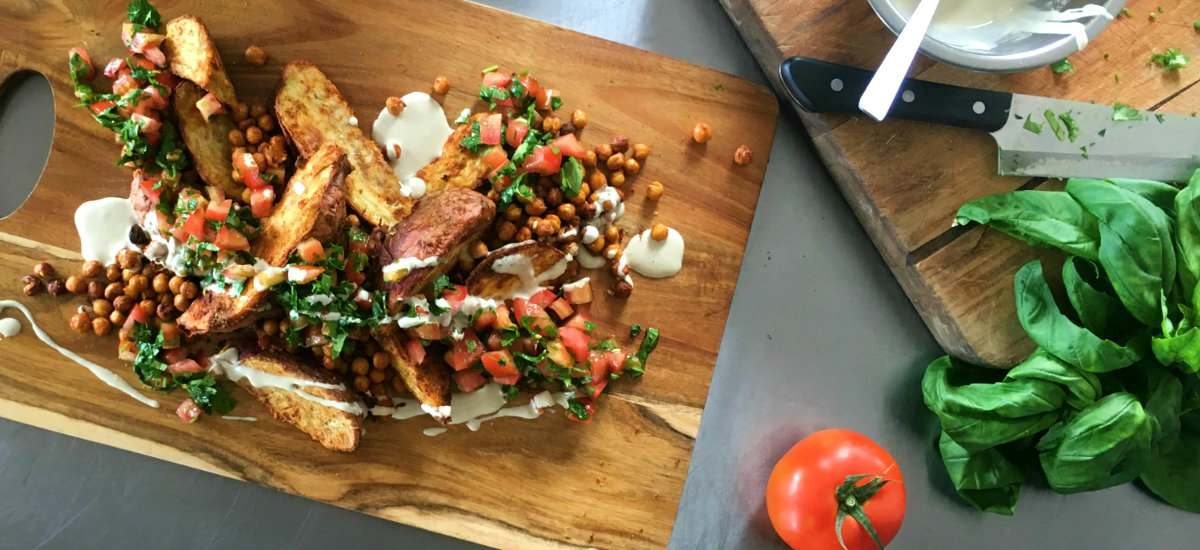 Mediterranean kumara with roast chickpeas, parsley, tomato salsa, and tahini