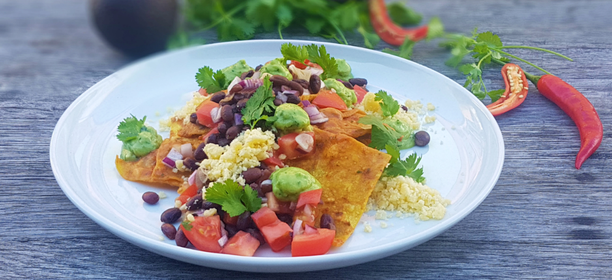 Chilaquiles with red sauce, avocado, bean salsa and Angel Foods cheddar