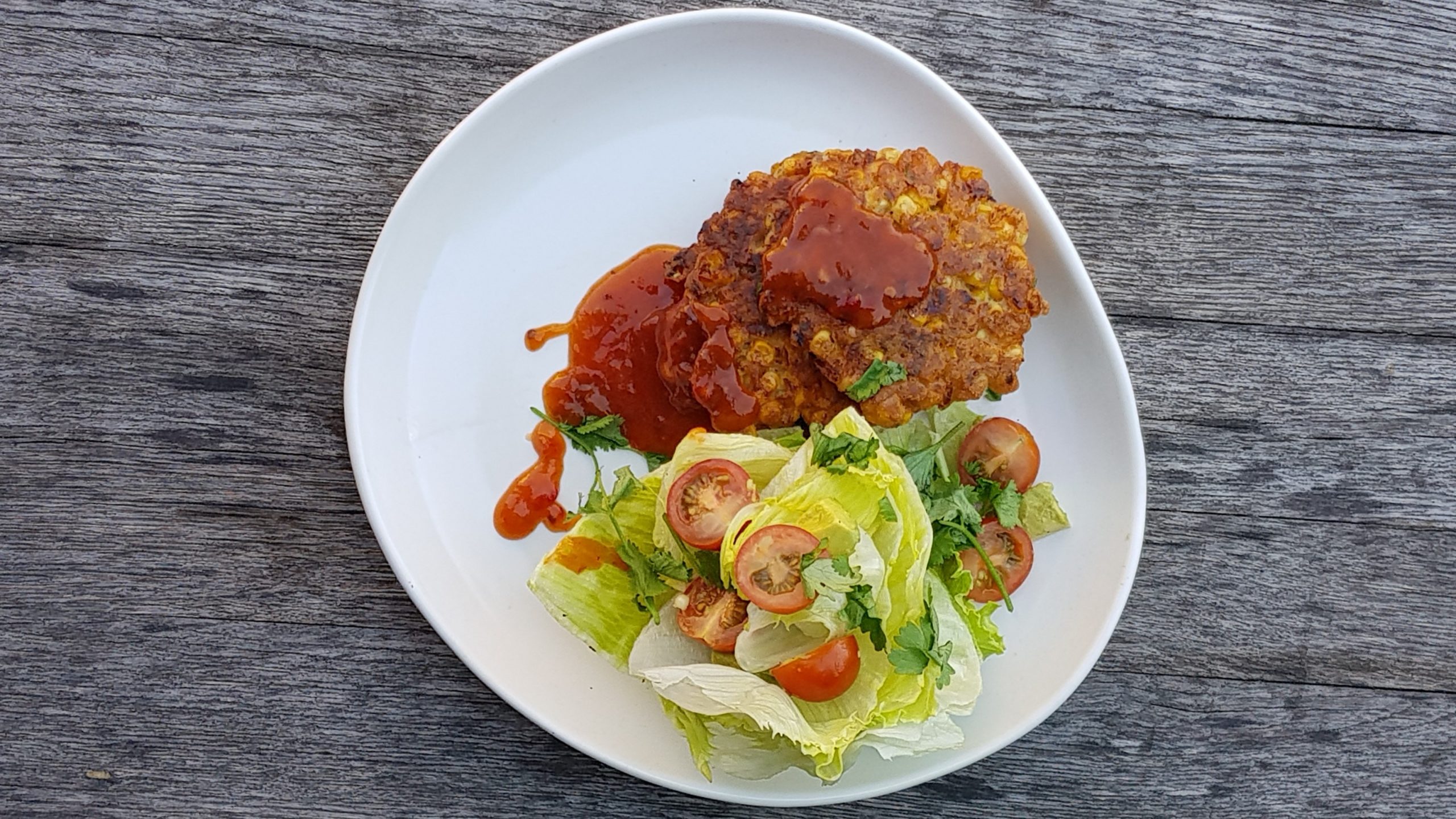 Corn fritters with sweet chili, wedge salad and cumin lime dressing