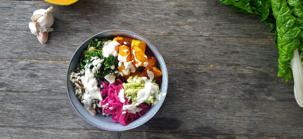 Winter bowl with roast pumpkin, sauerkraut, avocado, broccoli and almond ranch dressing