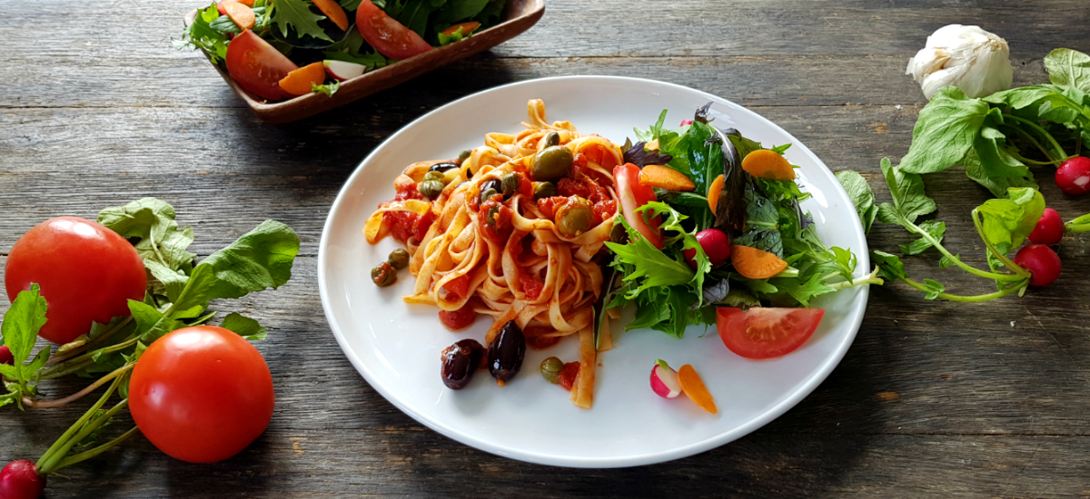 Spaghetti puttanesca in a Shiraz reduction with simple Italian greens