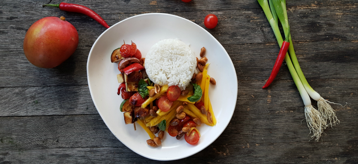 Teriyaki tofu skewers served with jasmine rice, mango peanut and chili salad