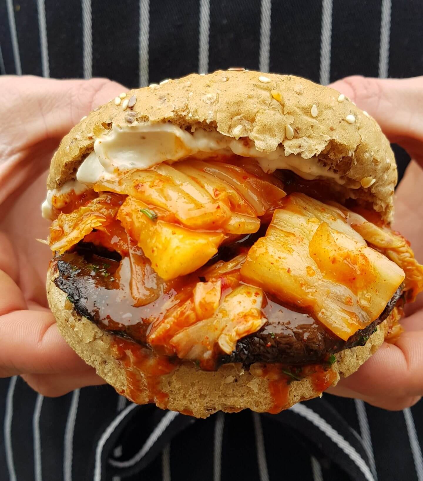 Korean portobello burger, kimchi and sesame cucumber with smashed potatoes and gochujang ketchup