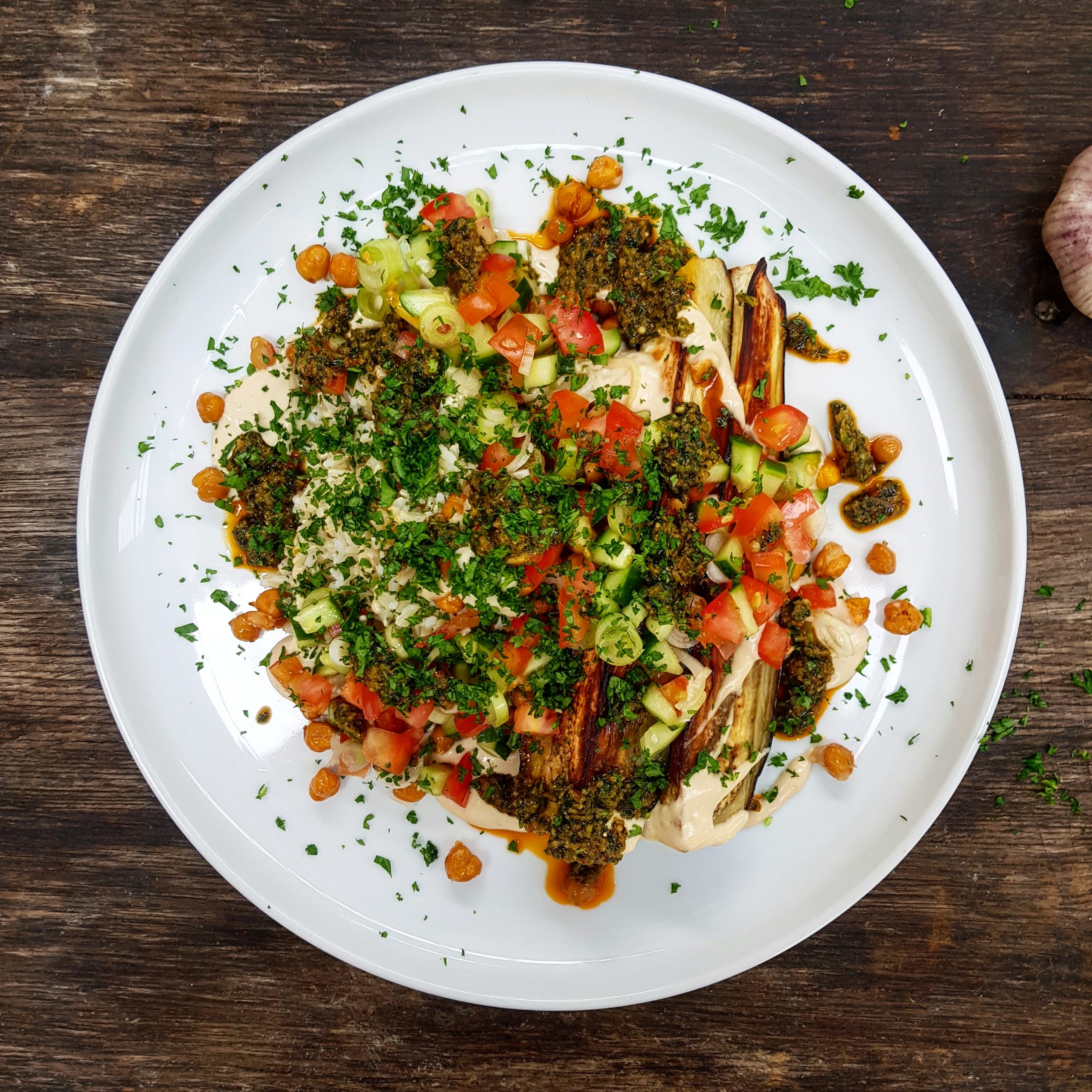 Eggplant, chickpea and zhoug sauce with tahini sauce, brown rice and salsa